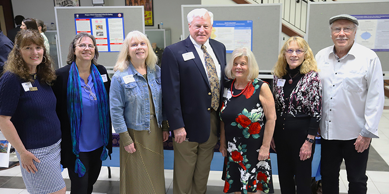 A group of adults posing for a photo