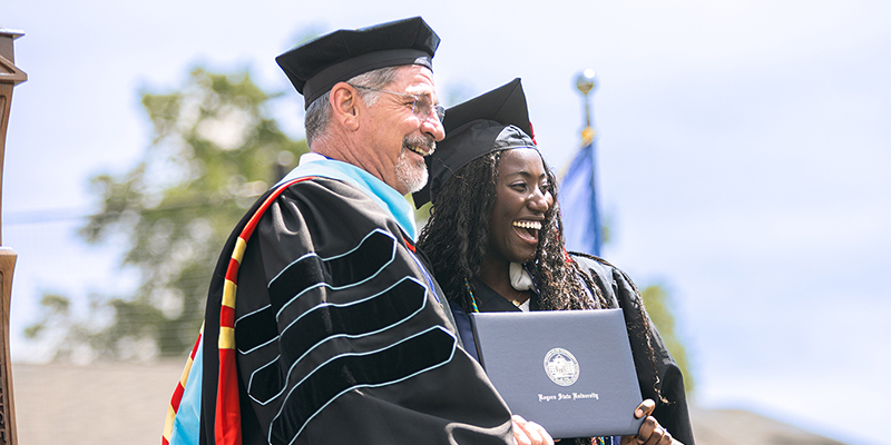 A man congratulates a female graduate