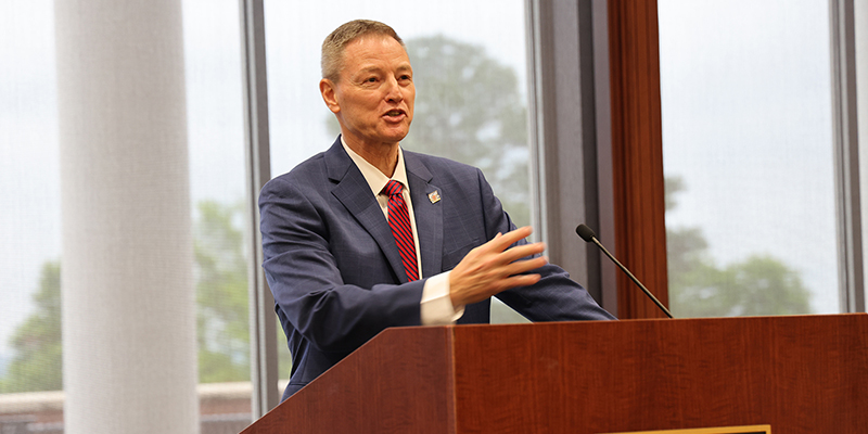 A man stands at a podium and speaks