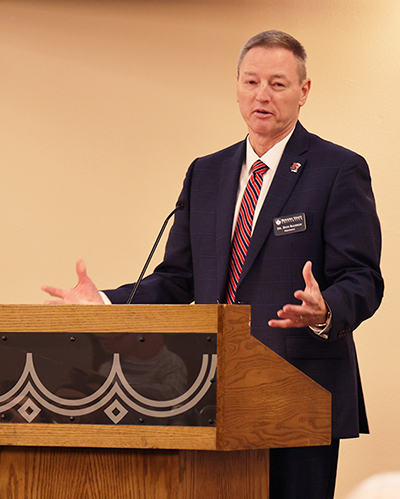 A man speaks from a podium