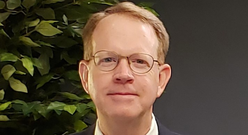 A smiling man with glasses