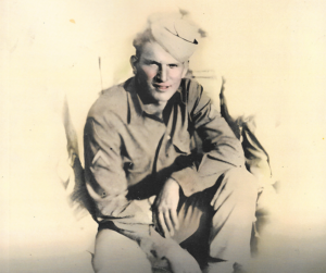 Military man sitting with thoughtful look.