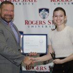 Hawken Grubbs, instructor of technology and justice studies, congratulated students on their outstanding showing in the National Cyber League Competition. A smiling male professor congratulates a student