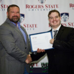 Hawken Grubbs, instructor of technology and justice studies, congratulated students on their outstanding showing in the National Cyber League Competition. A smiling male professor congratulates a student