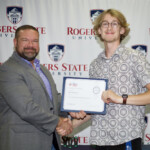 Hawken Grubbs, instructor of technology and justice studies, congratulated students on their outstanding showing in the National Cyber League Competition. A smiling male professor congratulates a student