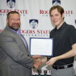 Hawken Grubbs, instructor of technology and justice studies, congratulated students on their outstanding showing in the National Cyber League Competition. A smiling male professor congratulates a student