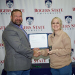 Hawken Grubbs, instructor of technology and justice studies, congratulated students on their outstanding showing in the National Cyber League Competition. A smiling male professor congratulates a student