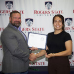 Hawken Grubbs, instructor of technology and justice studies, congratulated students on their outstanding showing in the National Cyber League Competition. A smiling male professor congratulates a student
